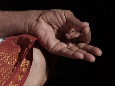 Detail of hands in a mudra position during meditation.